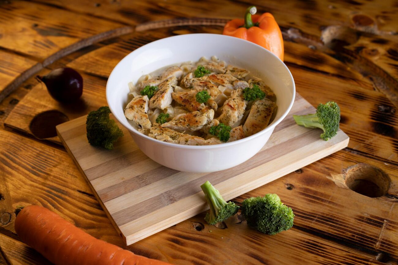 High protein cheesy garlic chicken with potatoes served on a plate