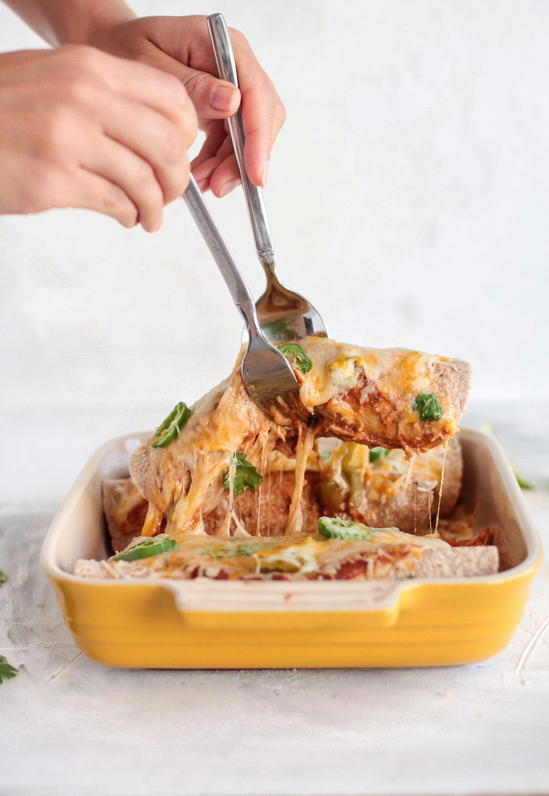 Cheesy breakfast enchiladas topped with melted cheese