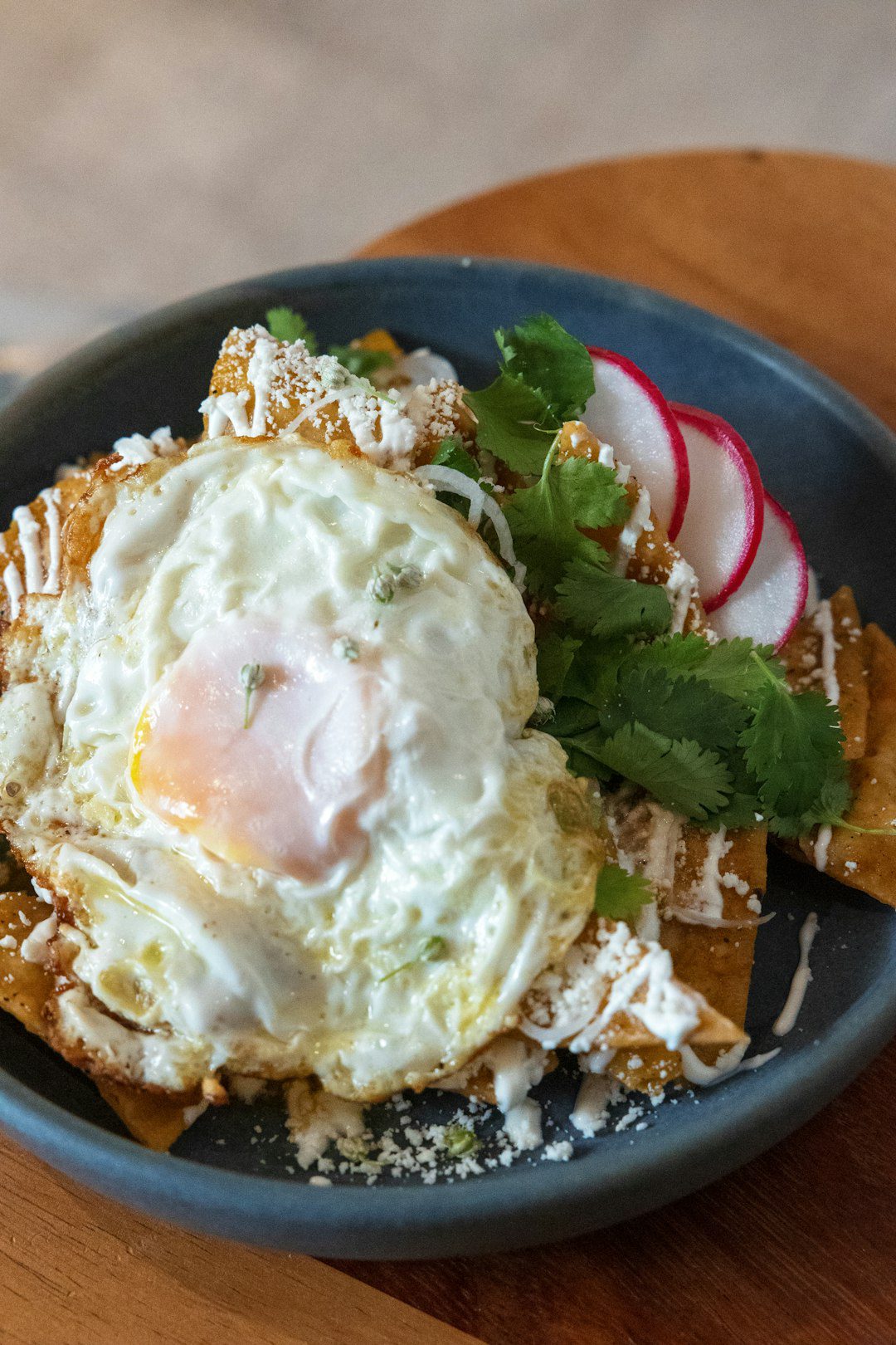 Crispy chilaquiles with eggs served on a plate