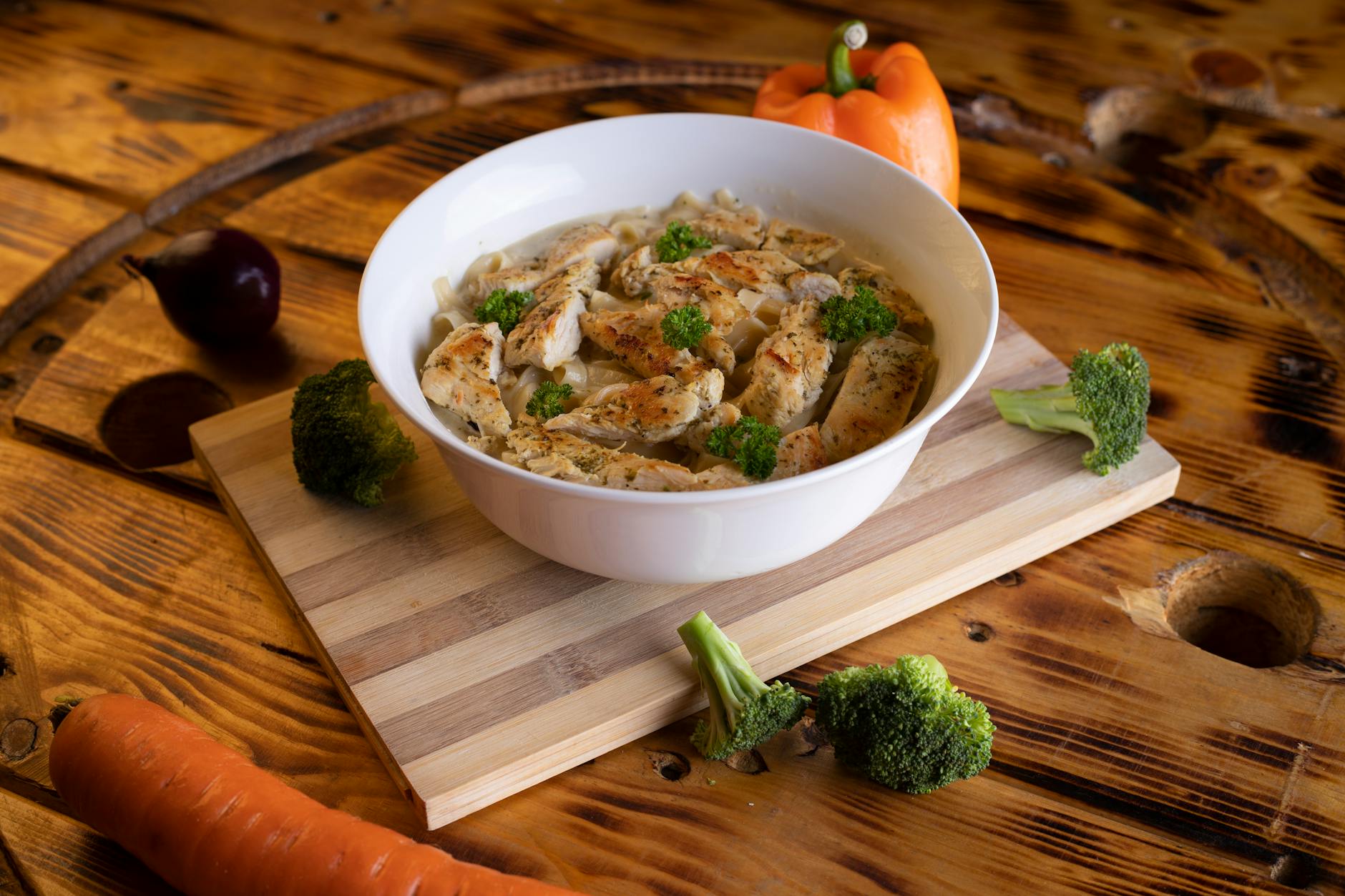 High protein cheesy garlic chicken with potatoes served on a plate